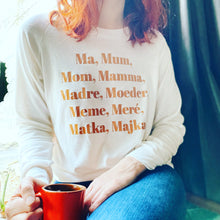 Load image into Gallery viewer, Ivory Raglan Crew neck with Clay Rose &quot;Mama&quot; graphic with the word mom in several languages, on a model.
